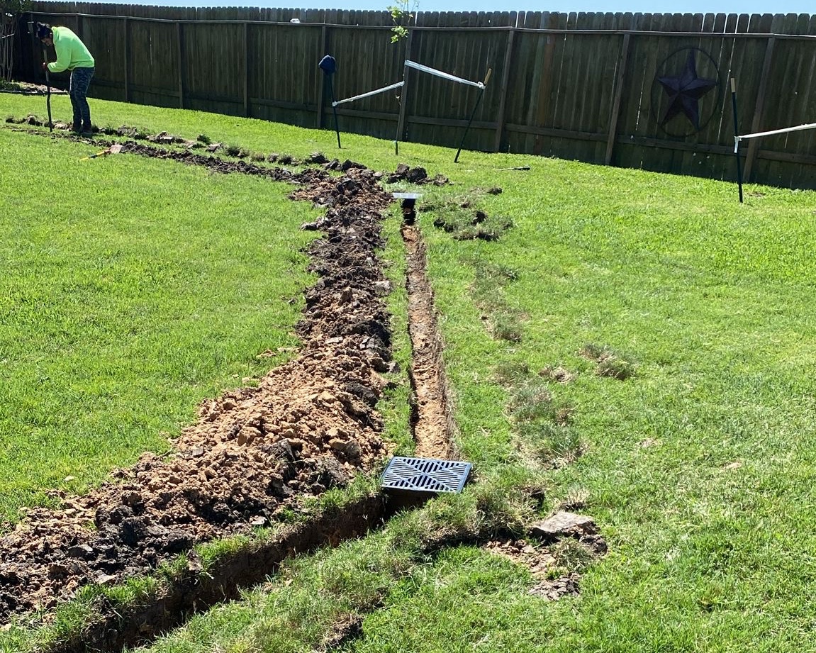 713 French Drains crew trenching a drainage system in a Houston backyard
