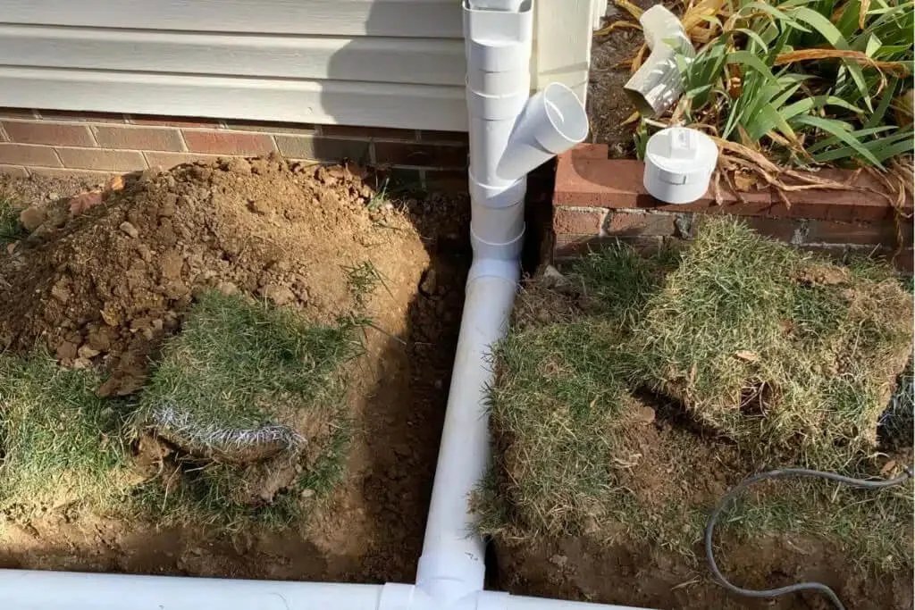 Buried downspout drainage lines installed in a Houston TX residential yard