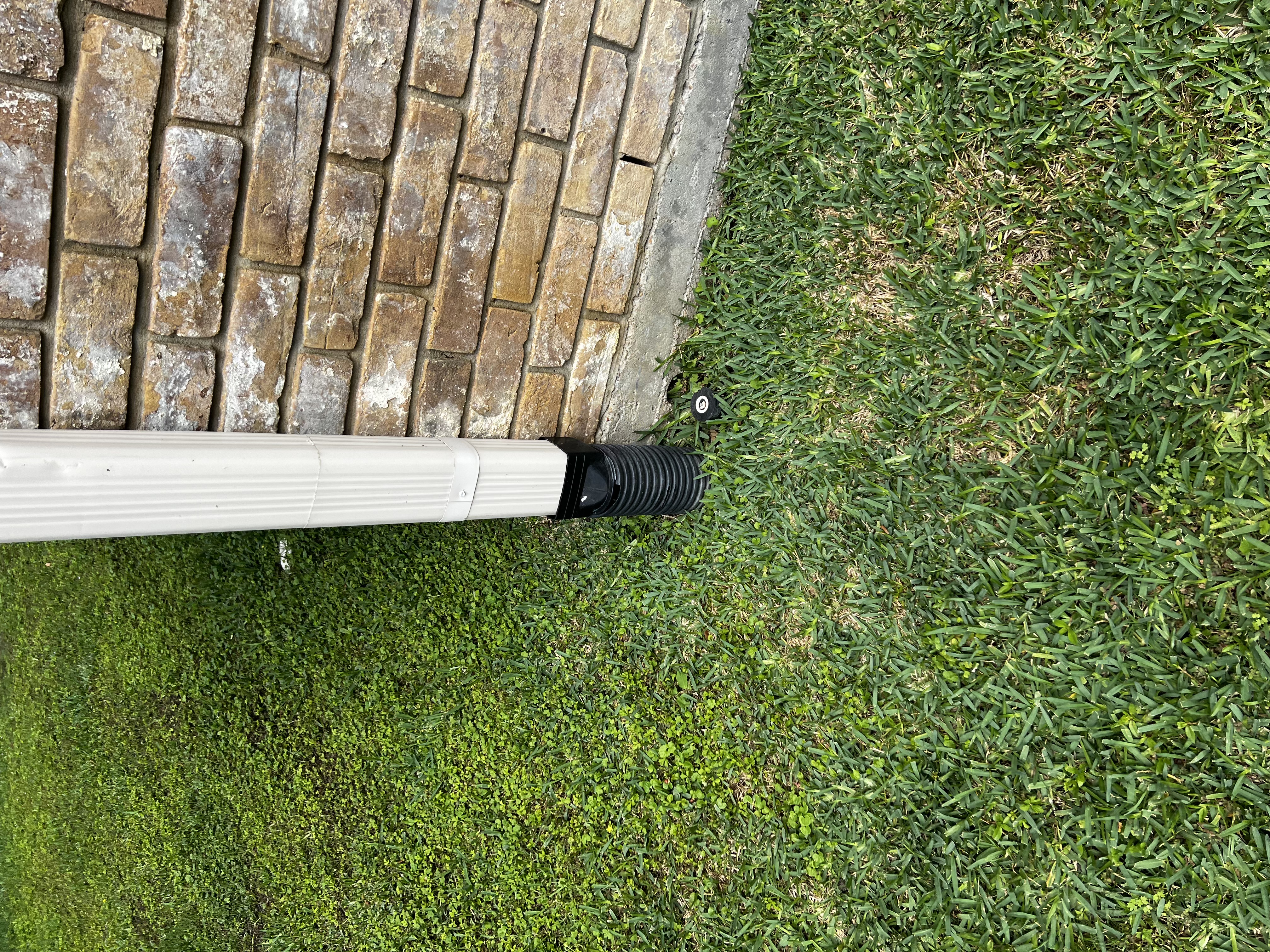 Professional downspout extension connection installed at a Houston TX home