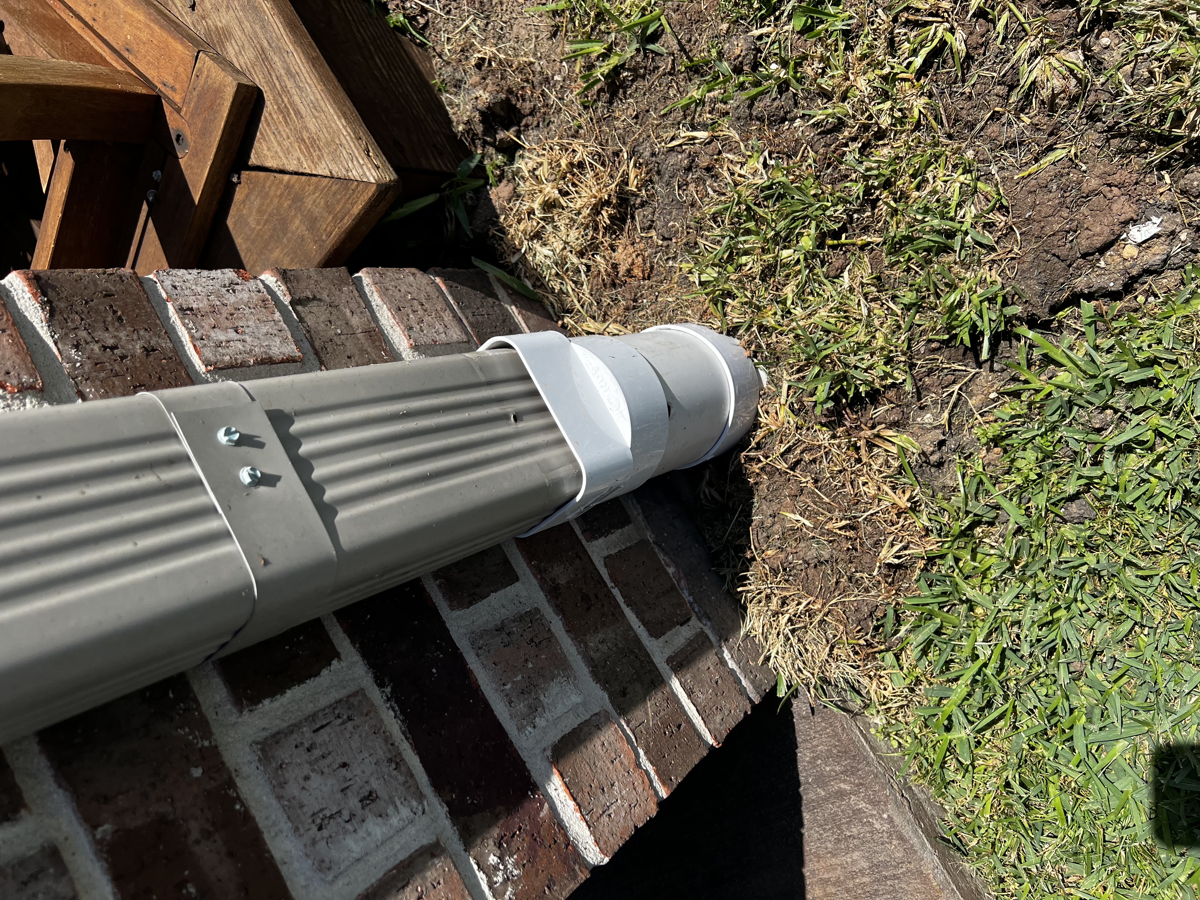 Professional PVC downspout extension installation at a Houston TX home