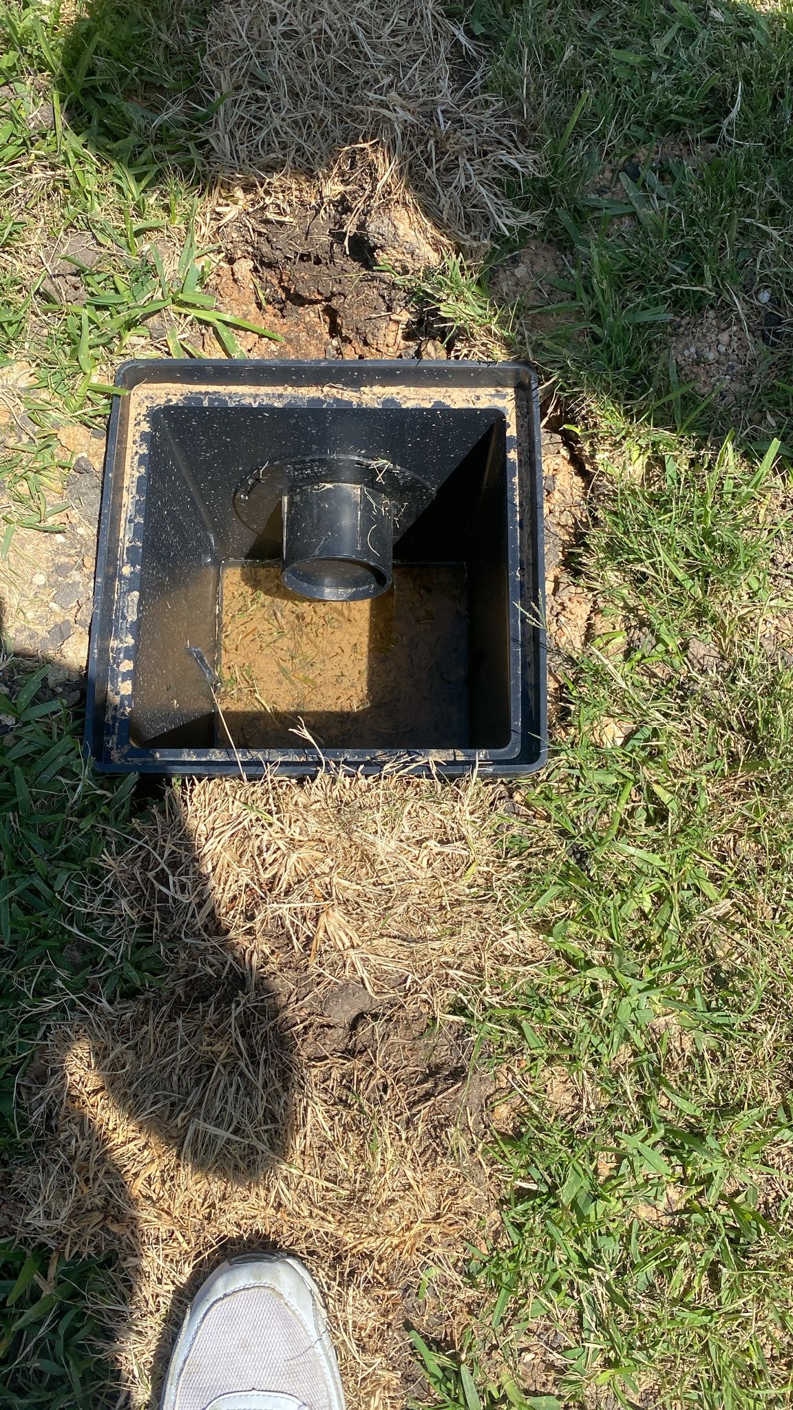 Using a level to ensure proper drainage pipe slope during repair in Houston TX