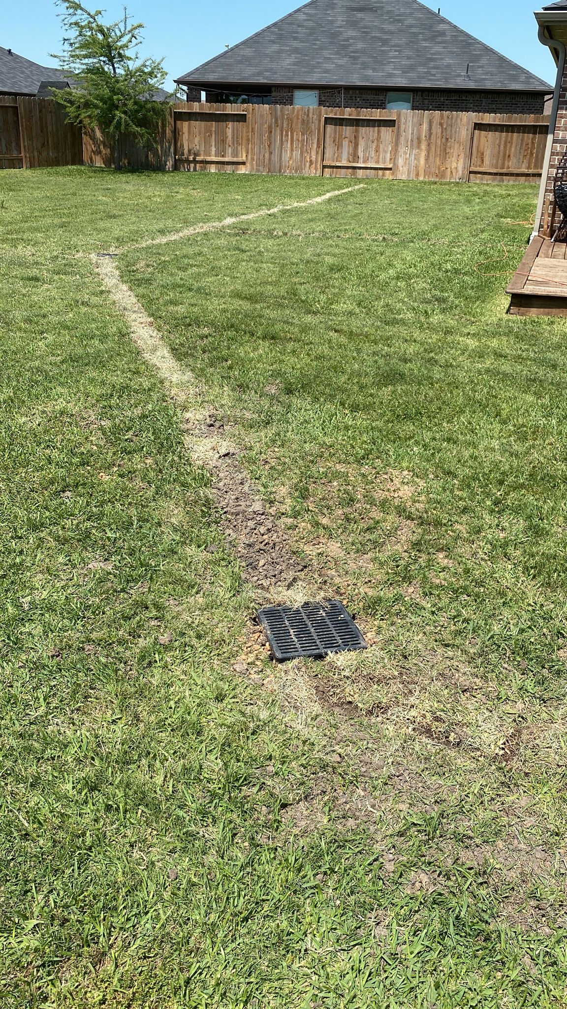 Completed French drain system with catch basin in a Houston residential yard