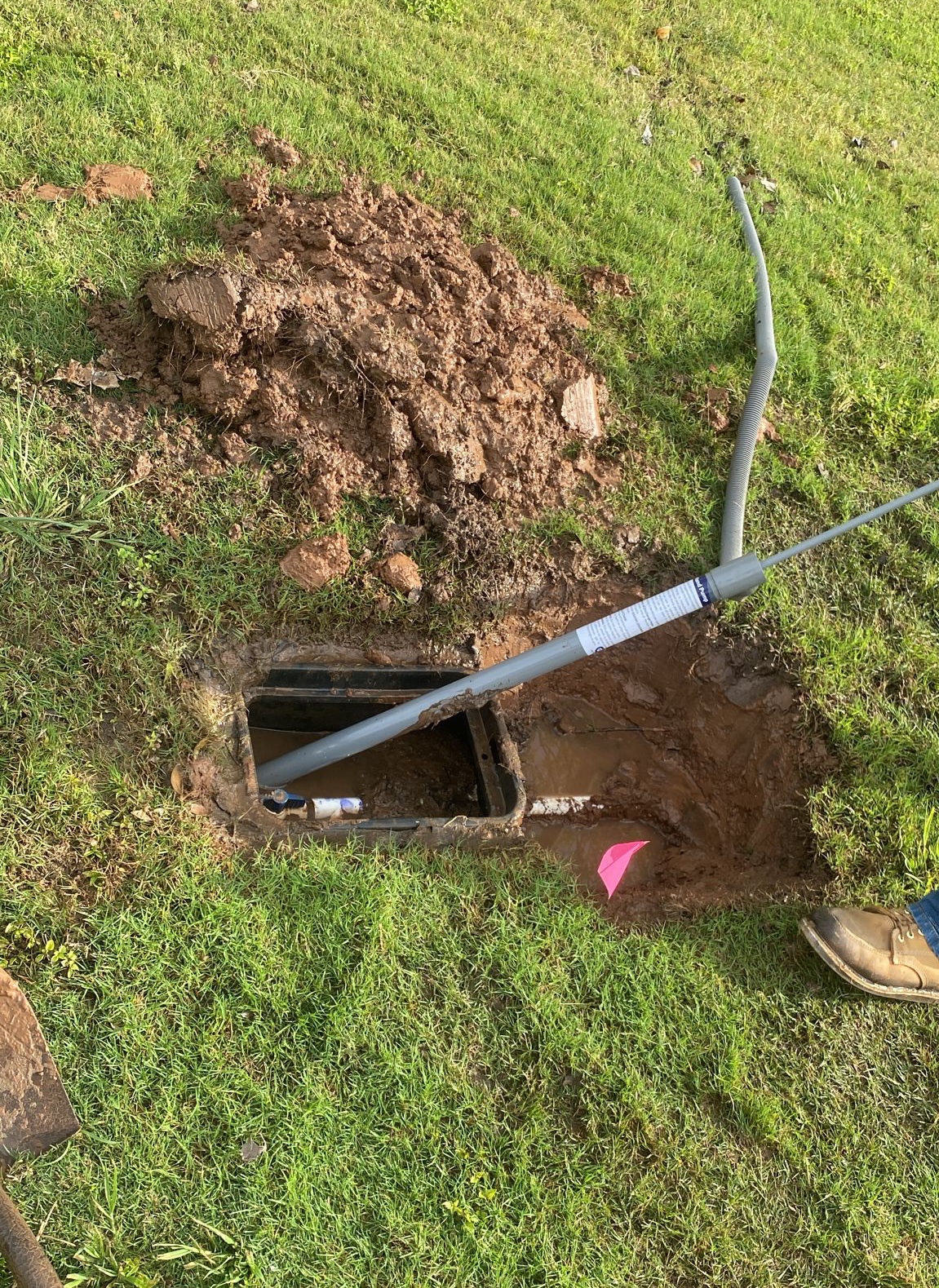 French drain cleanout access point excavated for professional maintenance in Houston