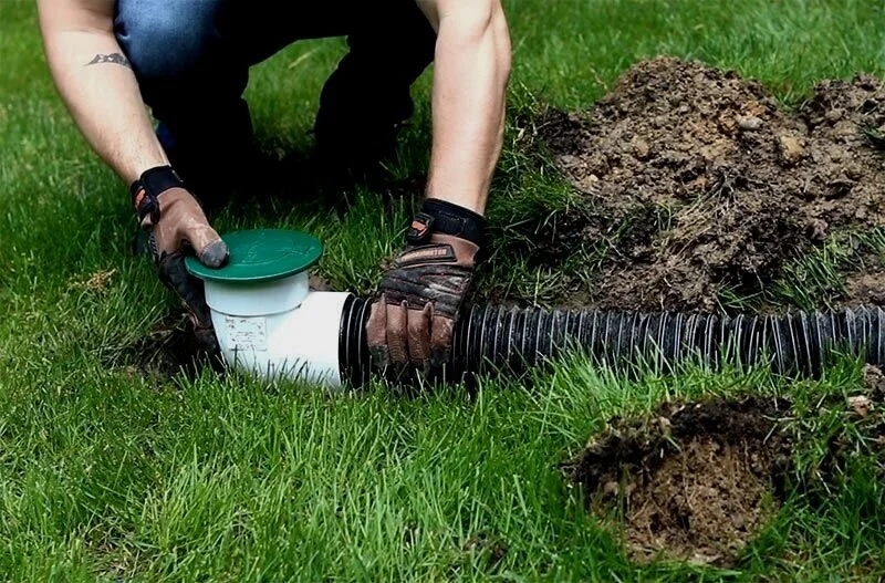 Pop-up drain emitter close-up installed in Houston TX lawn